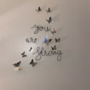 Metal wording with mirrored butterflies